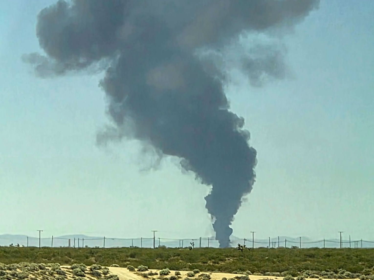 Smoke rises from a B-52 bomber that crashed shortly after takeoff at a US Air Force base in Southern California on June 15, 2026 [Debbie Reyes Katz/AP]