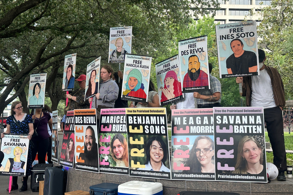 photos in support of eight defendents outside a courthouse