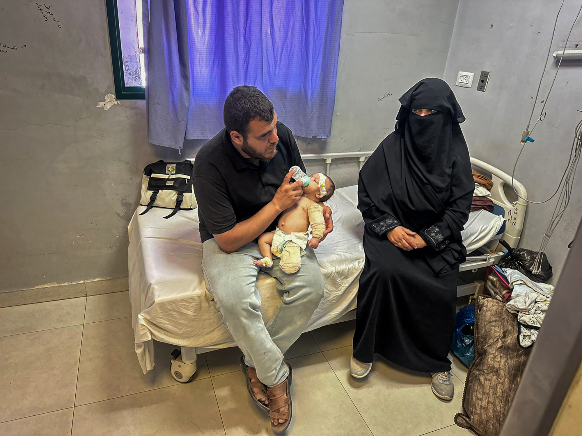 Ahmed al-Khatib with Mohammed and the baby’s grandmother at Nasser Medical Complex in Khan Younis, southern Gaza