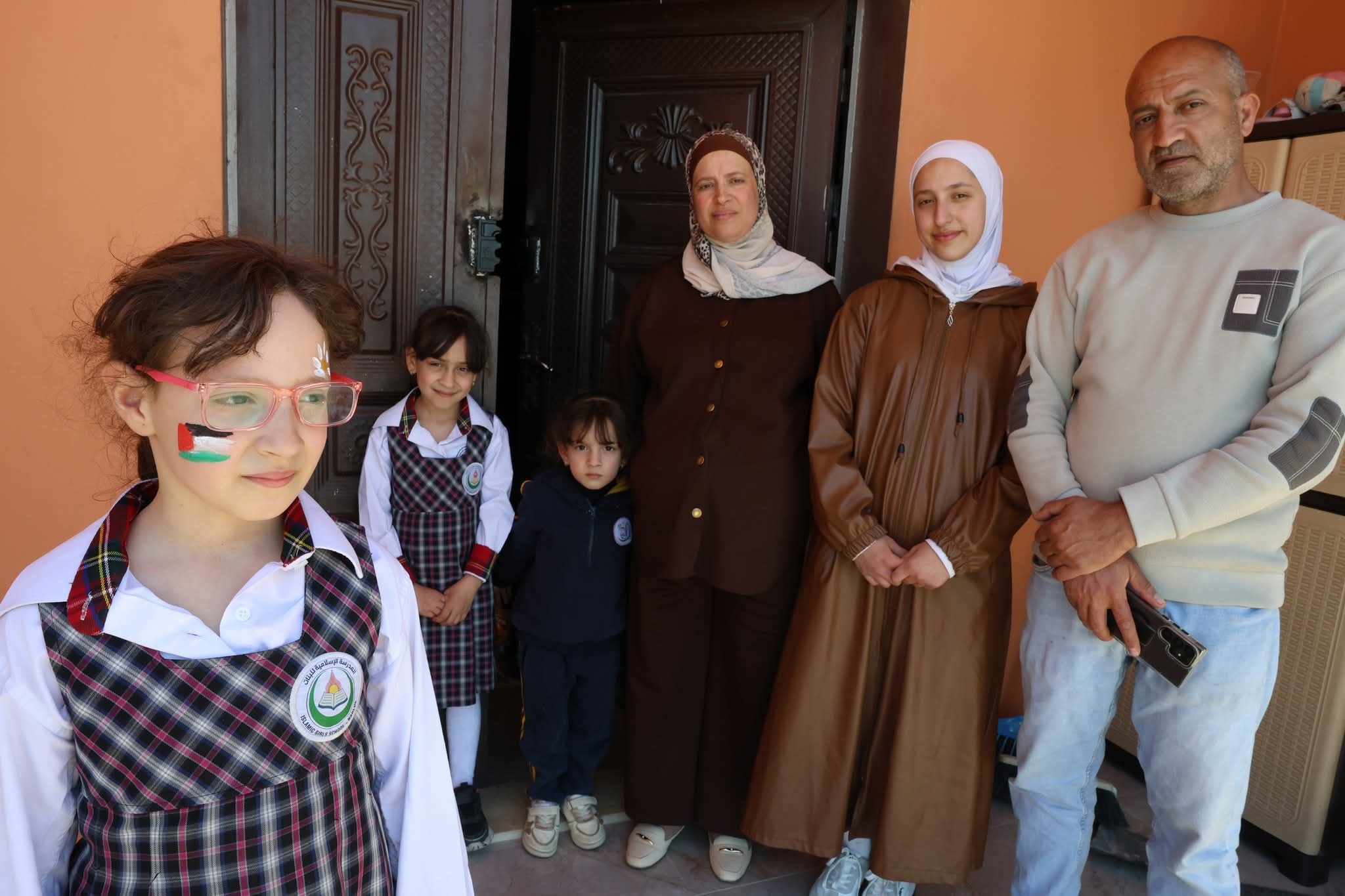 Sadeq Faqih, 41, stands with his wife Abeer and their daughters outside their home in Beit Imrin, which was targeted in a terrifying settler raid.