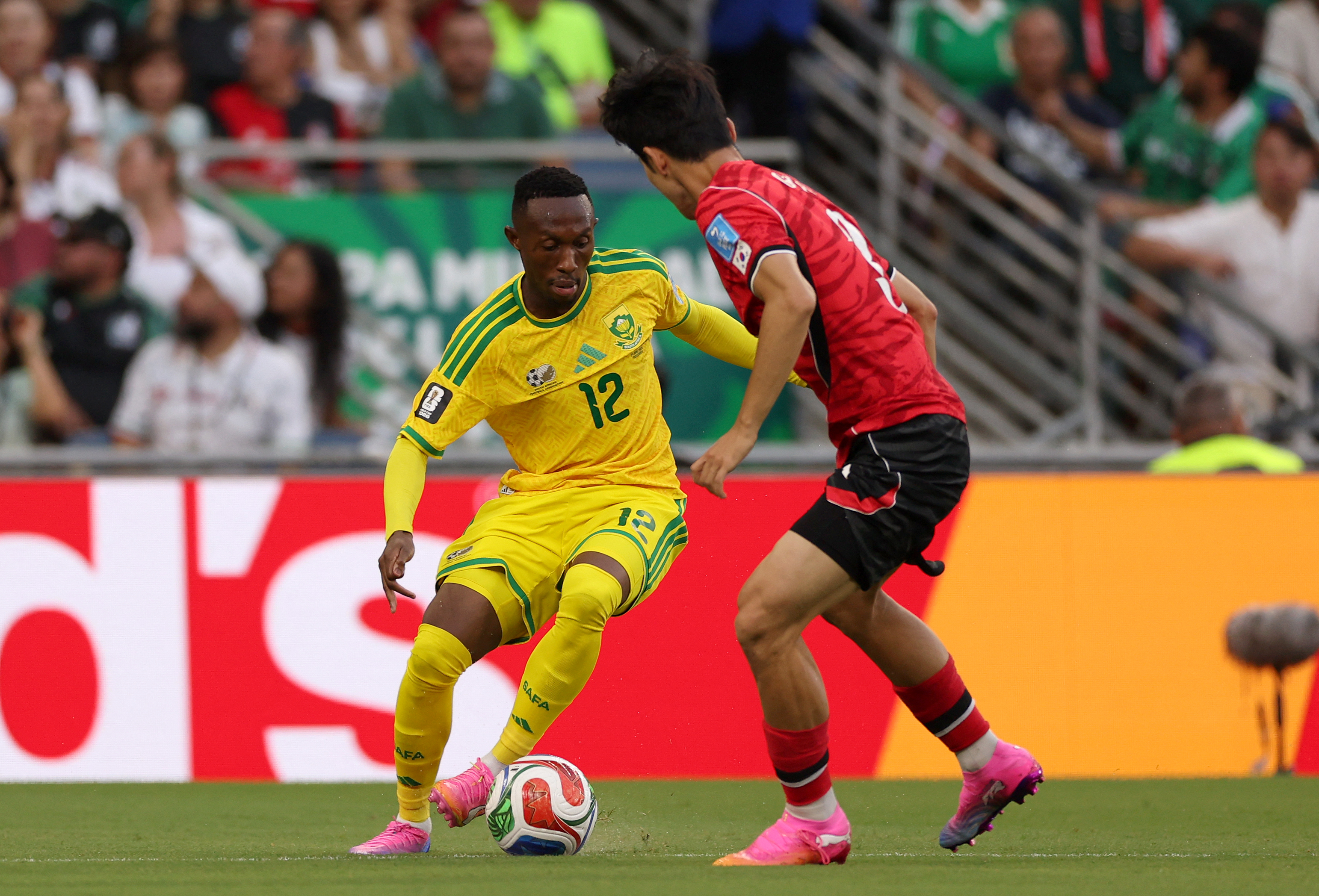 South Africa's forward #12 Thapelo Maseko controls the ball as he's defended by South Korea's defender #03 Lee Gi-hyuk during the 2026 World Cup Group A football match between South Africa and South Korea at the Monterrey Stadium in Guadalupe, Mexico, on June 24, 2026.