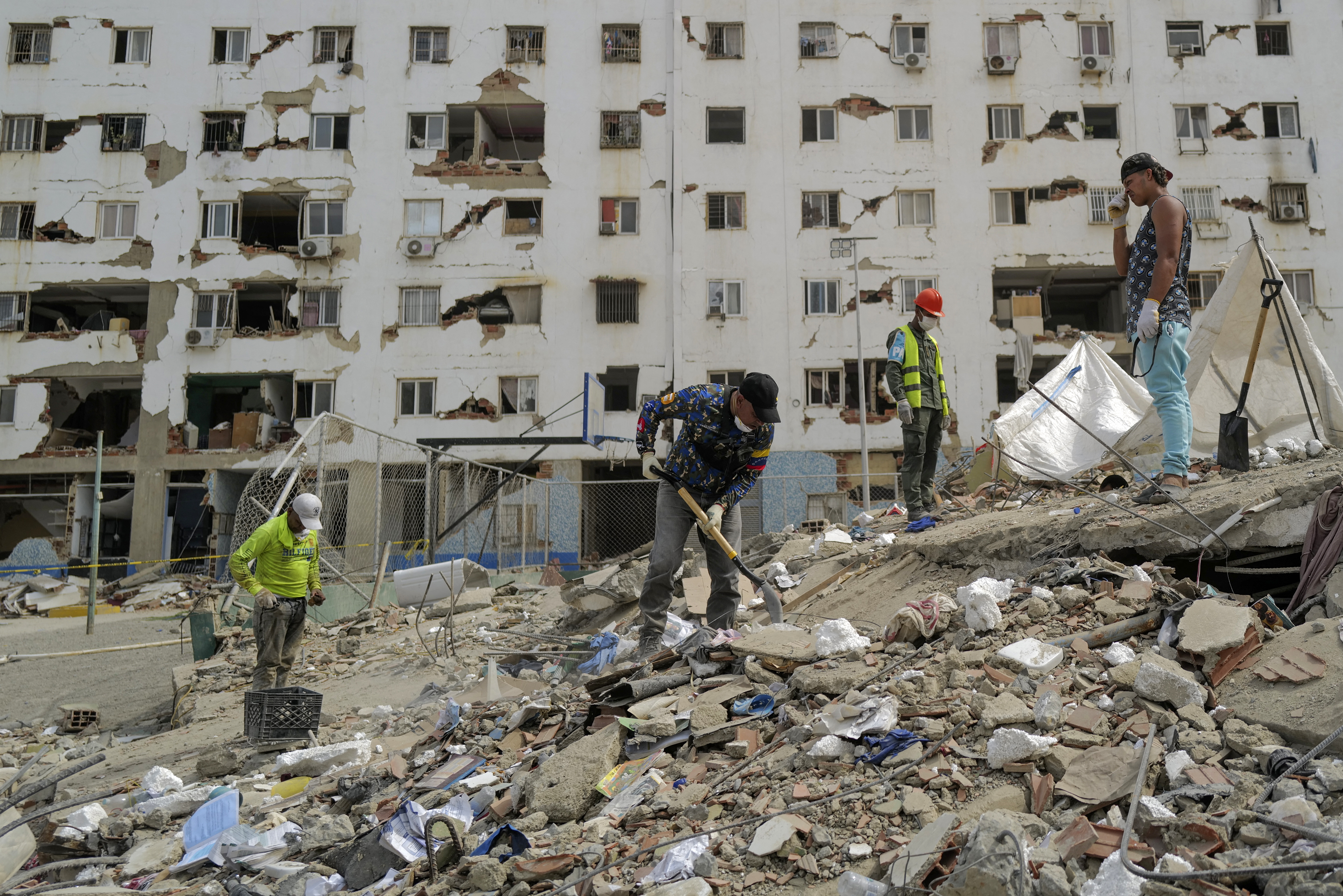 A rescuer digs amid rubble while searching for victims in Caraballeda, La Guaira State, Venezuela on June 28, 2026, following twin earthquakes.