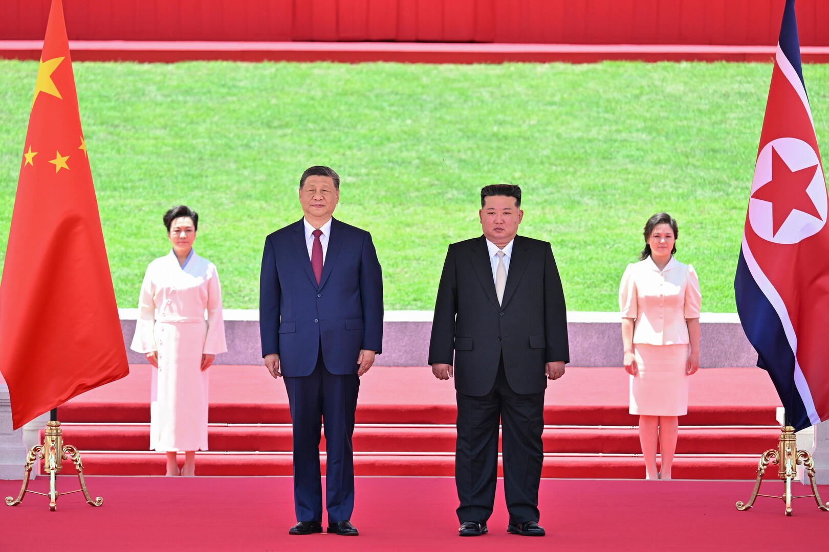 In this photo released by Xinhua News Agency, Chinese President Xi Jinping, center left, and North Korean leader Kim Jong Un watch a march-past during a welcome ceremony in Pyongyang on Monday, June 8, 2026. [Yin Bogu/Xinhua/AP]