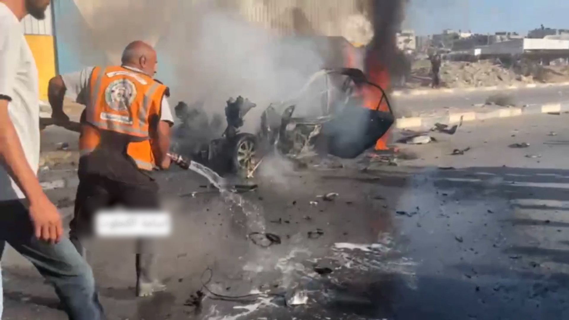 Man extinguishes car on fire after double tap Israeli attack in Gaza
