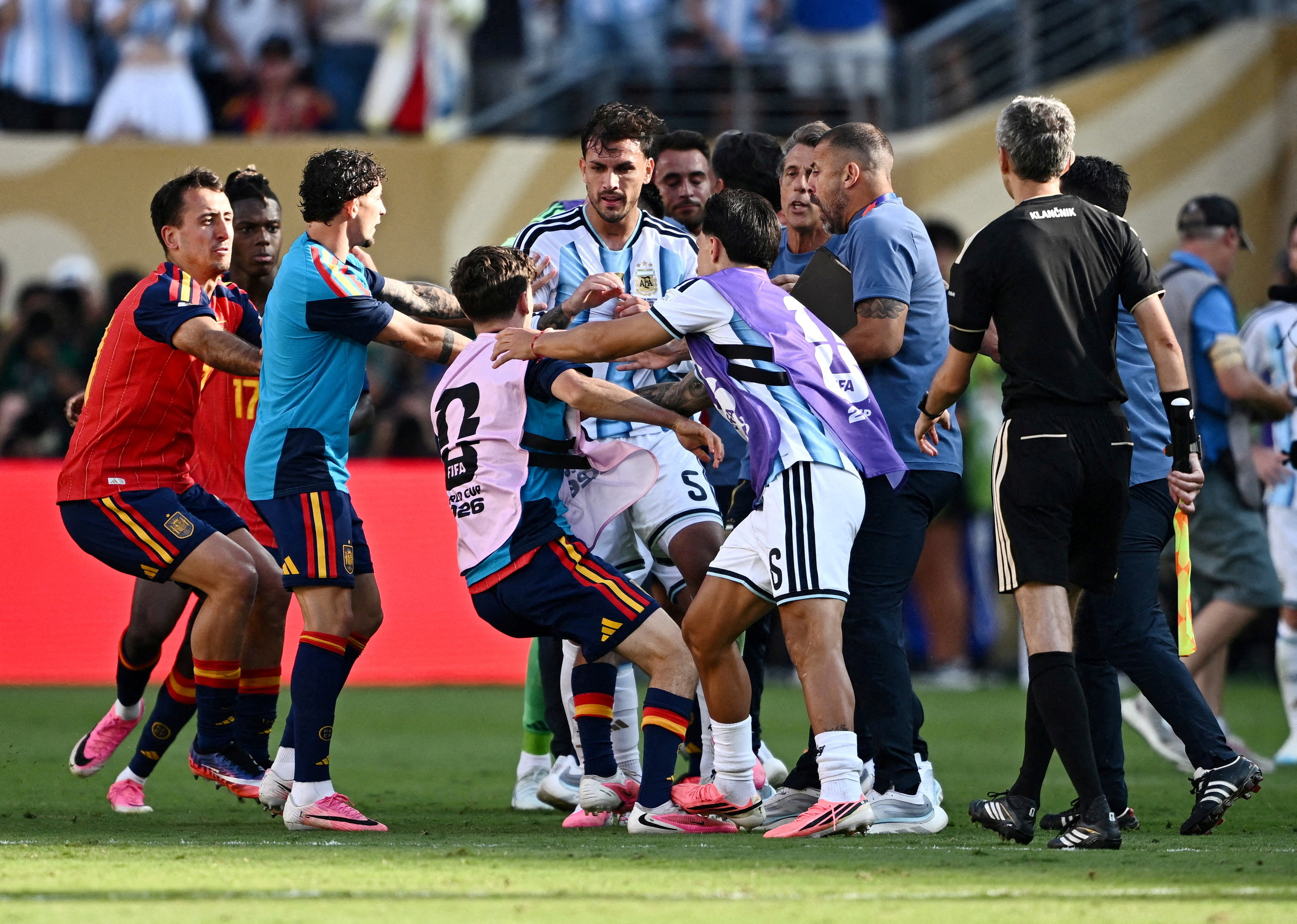 Argentina's Leandro Paredes and Lisandro Martinez clash with Spain's Gavi after the match