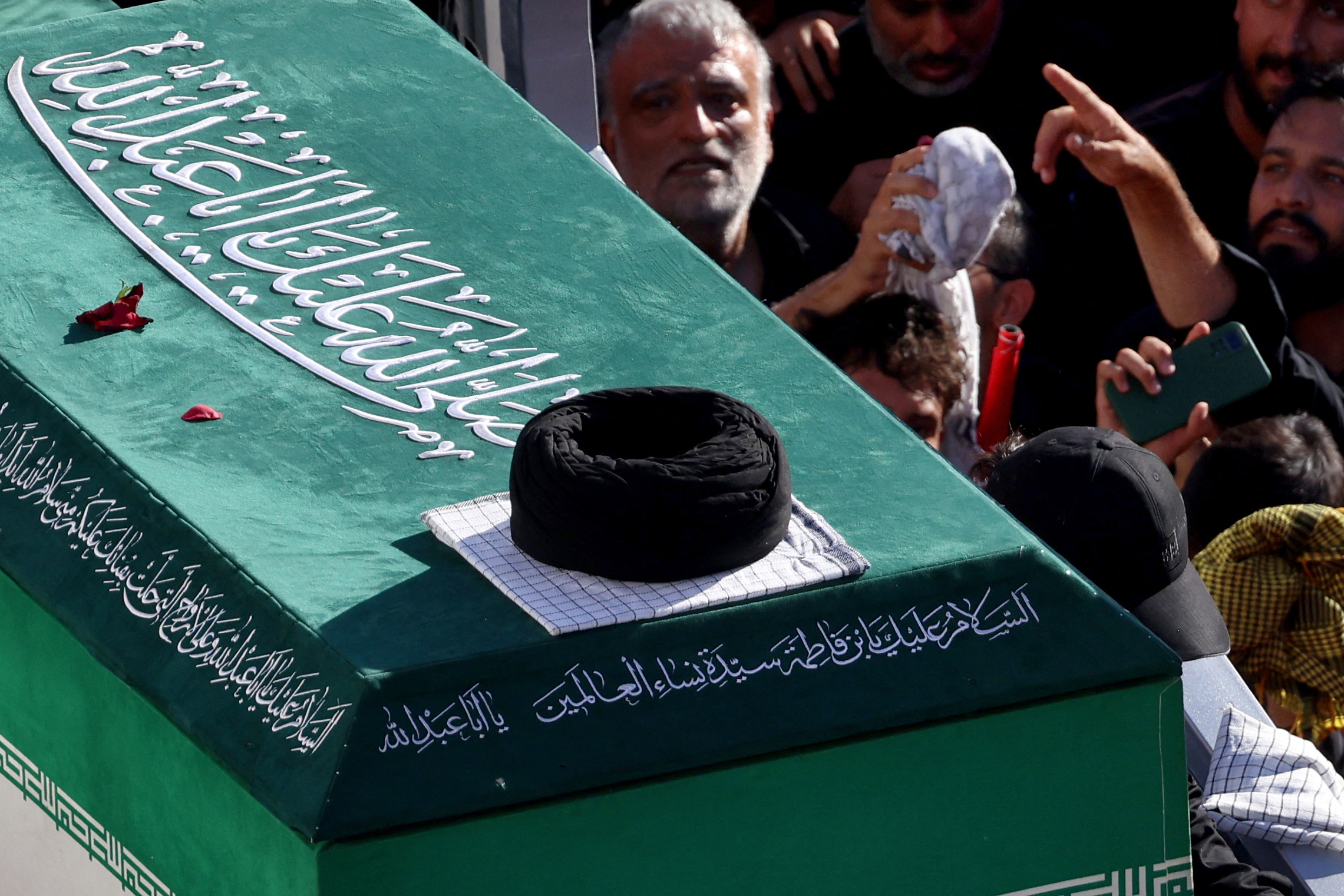 Crowds of mourners surround the convoy carrying the coffins of Iran's slain supreme leader Ali Khamenei and members of his family during a funeral procession, before he is buried at the Shrine of Imam Reza, Iran's most revered place of worship, in Mashhad on July 9, 2026. Braving sweltering heat and calling for revenge, Iranians loyal to the Islamic republic massed on July 9 for the burial of slain supreme leader Ali Khamenei in his hometown of Mashhad. (Photo by ATTA KENARE / AFP) /