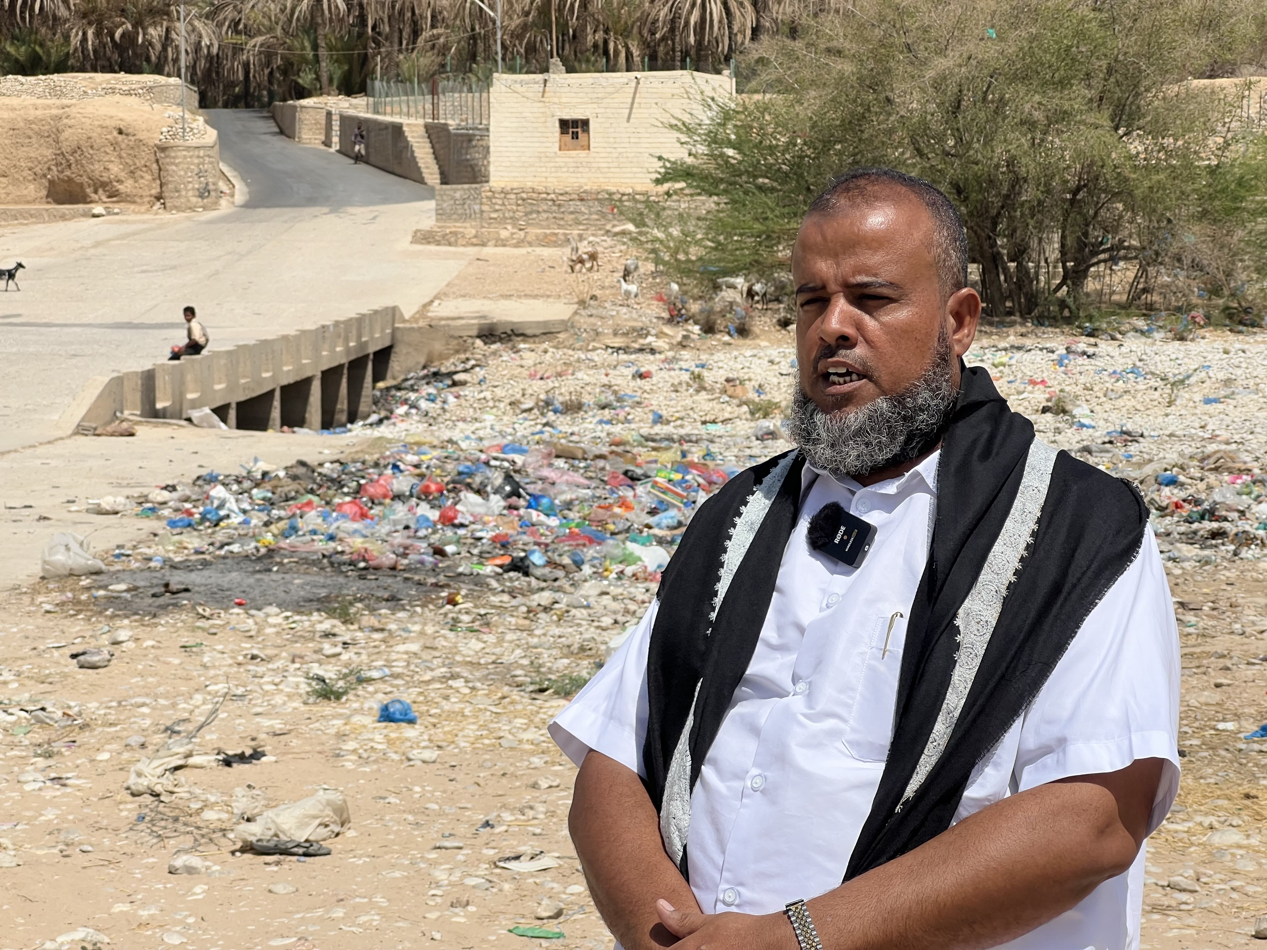 Salem Raji, an agricultural official and researcher, spoke to a local media center to raise awareness among residents about the risks of dumping waste into valleys. He was standing beside a pile of rubbish in Wadi