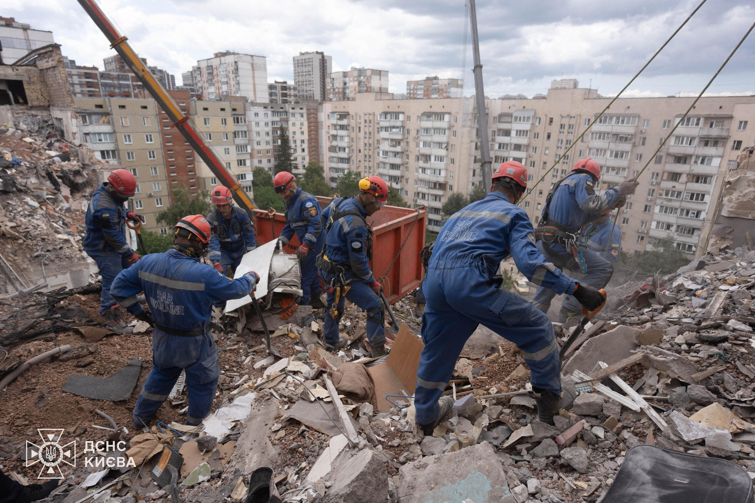 This handout picture taken and released by Ukrainian State Emergency Service on July 6, 2026 shows rescuers working on a residential building partially destroyed as a result of Russian missile strike on the Ukrainian capital of Kyiv, amid the Russian invasion in Ukraine.