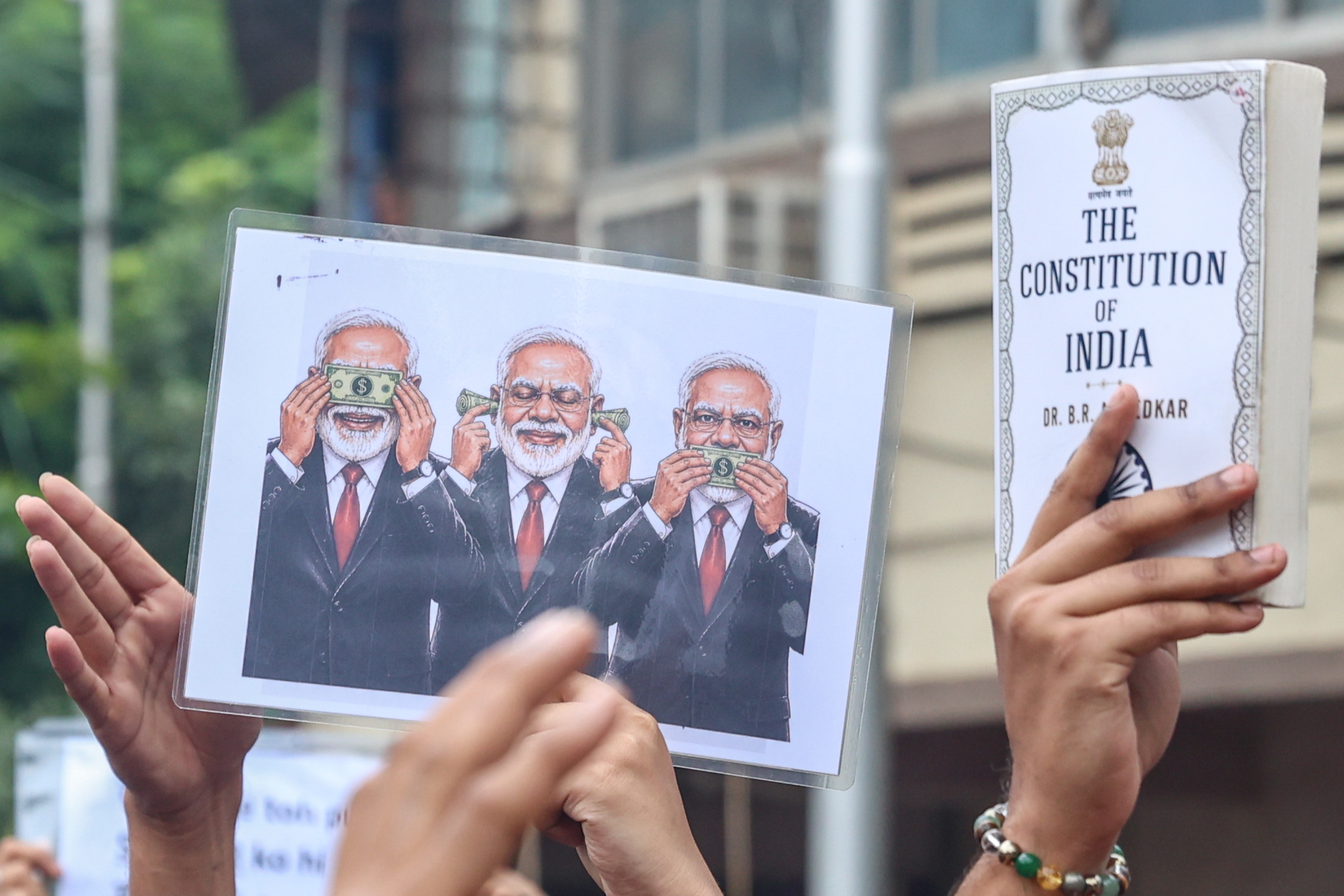 epa13123253 Supporters of the Cockroach Janta Party (CJP) hold a placard depicting Indian Prime Minister Narendra Modi as they gather for a protest march in Mumbai, India, 20 July 2026, demanding Union Education Minister Dharmendra Pradhan's resignation over alleged examination paper leak irregularities. The youth-led movement gathered for the march after police forcibly removed and hospitalized activist and educator Sonam Wangchuk over health concerns following his three-week hunger strike. EPA/DIVYAKANT SOLANKI