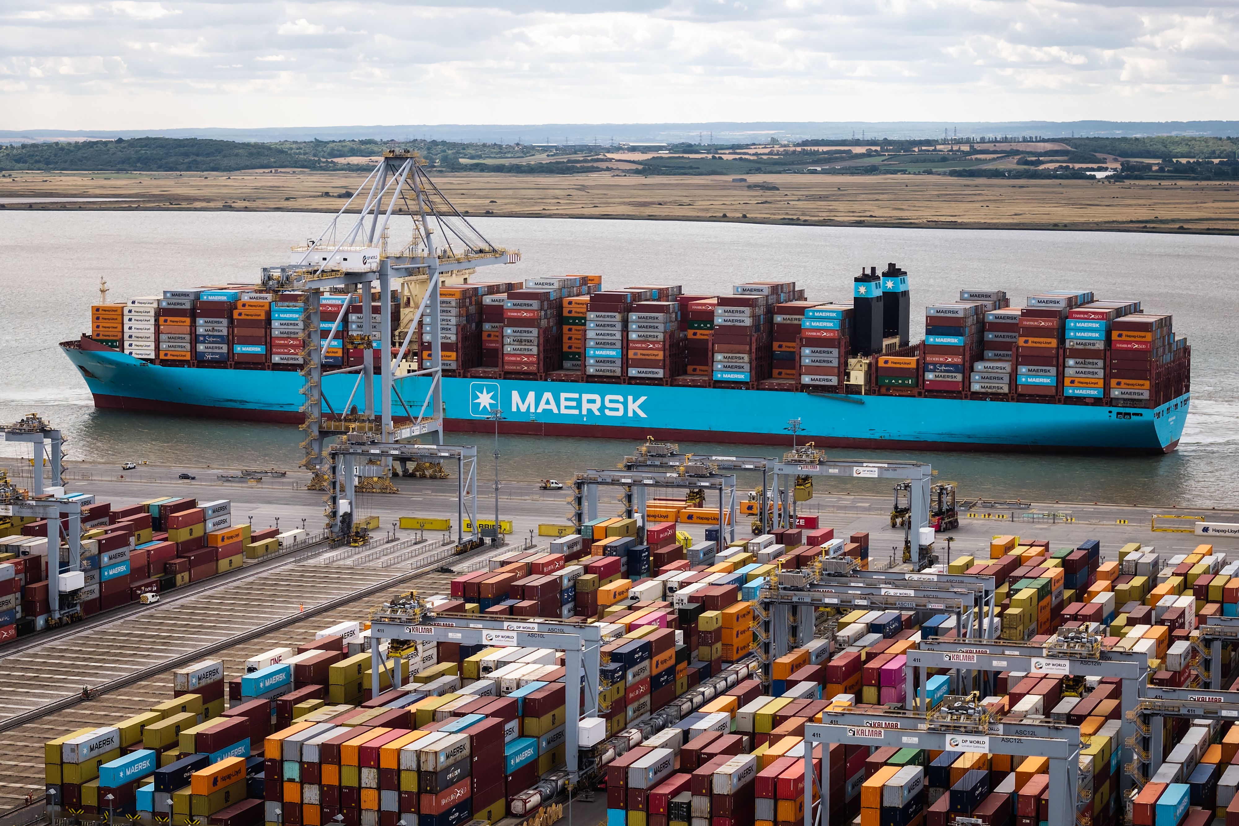 BASILDON, ENGLAND - JULY 27: A Maersk shipping container ship is manoeuvred towards the cranes as it prepares to unload its cargo at the London Gateway Port on July 27, 2026 near Basildon, England. In the latest round of U.S. President Donald Trump's tariffs announced on July 23, countries including the UK, European Union, and China will face 10% to 12.5% levies on most goods imported to America. A statement by United States Trade Representative Jamieson Greer said that the tariffs would be imposed on 60 economies, "for their failure to impose and effectively enforce a prohibition on the importation of goods produced with forced labor." The impact on UK exports remains minimal, as the most recent tariffs replace similar ones that were due to expire. (Photo by Leon Neal/Getty Images)