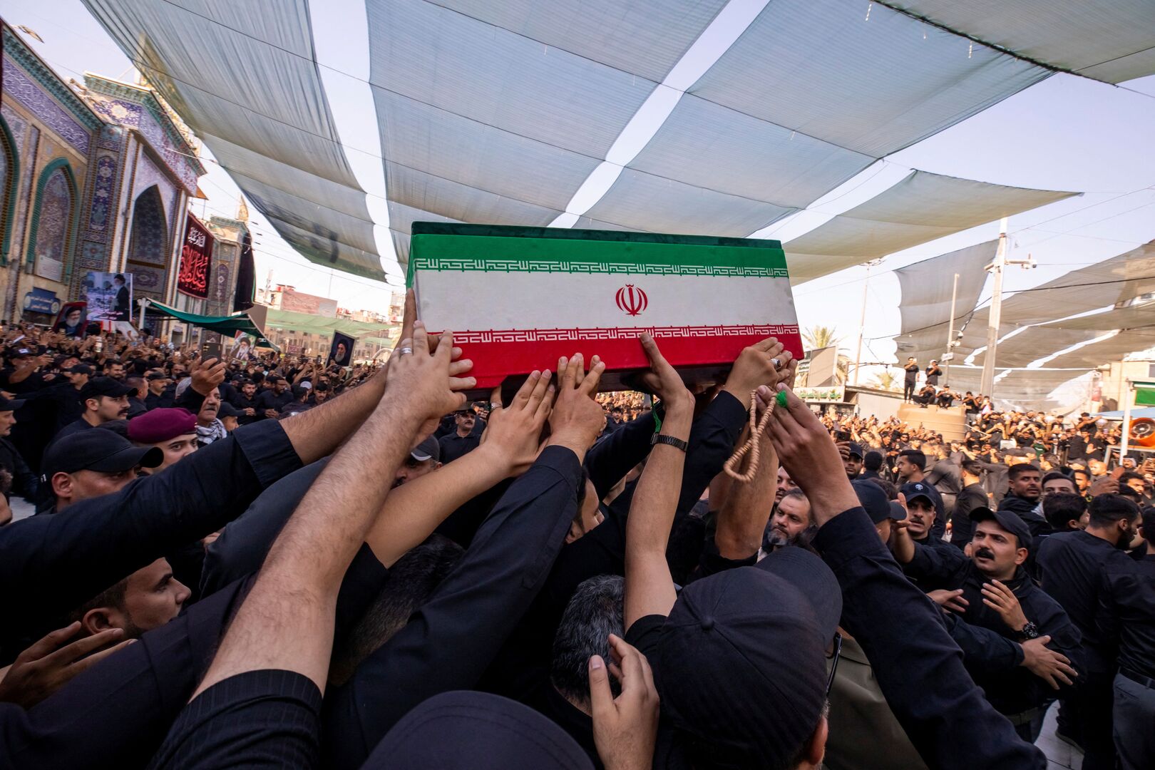 Mourners carry one of the coffins of family members of Iran&rsquo;s late Supreme Leader Ayatollah Ali Khamenei, who was killed on February 28 during Israeli and U.S. airstrikes on Iran, during funeral ceremonies in Karbala, Iraq, July 8, 2026. [Abbas Holy Shrine Media Office/Reuters]