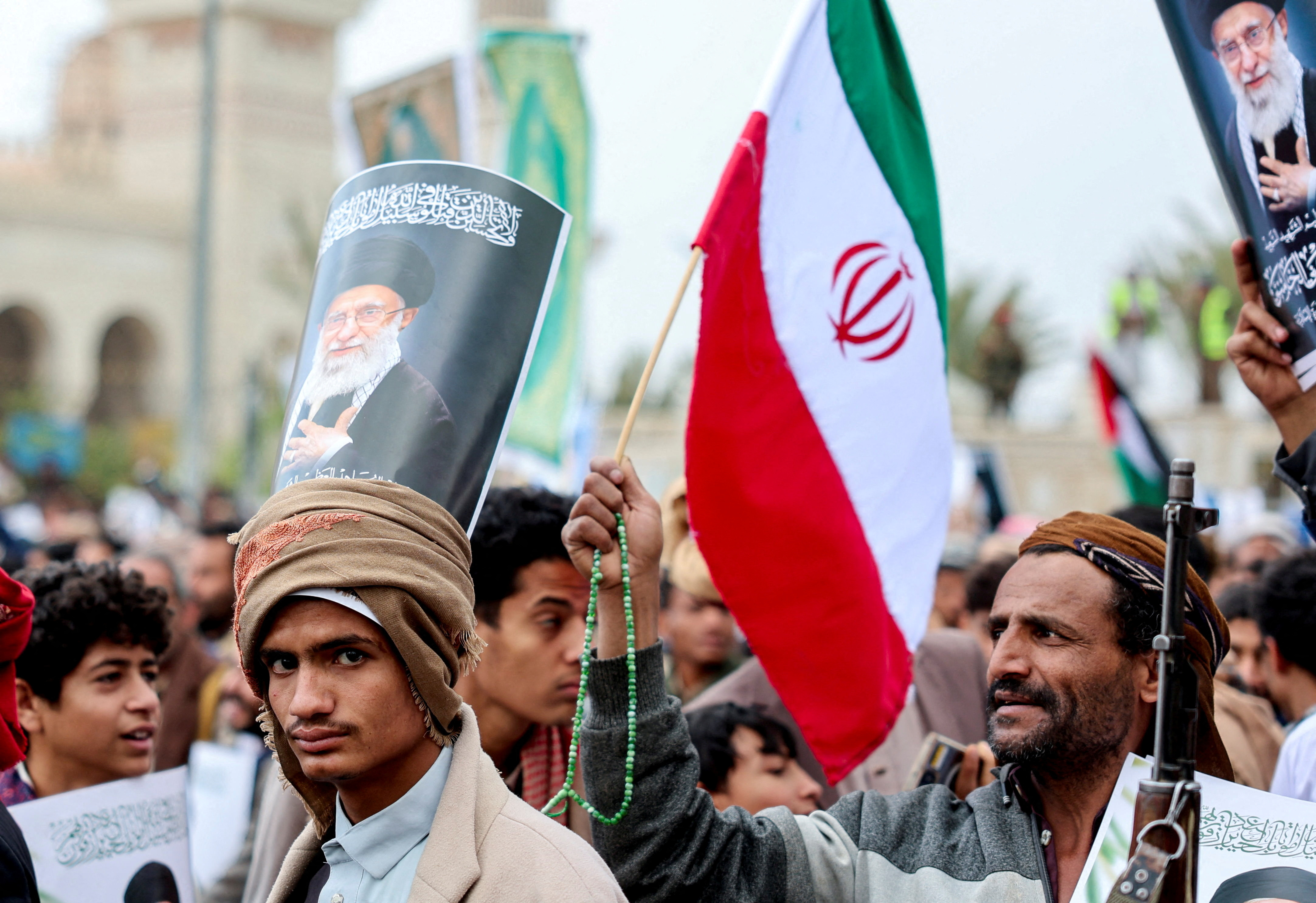 FILE PHOTO: A protester with a poster featuring a picture of late Iran's Supreme Leader Ayatollah Ali Khamenei on his head joins a demonstration with Houthi supporters in solidarity with Iran and Lebanon, amid the U.S.-Israeli conflict with Iran, in Sanaa, Yemen March 6, 2026. REUTERS/Khaled Abdullah/File Photo