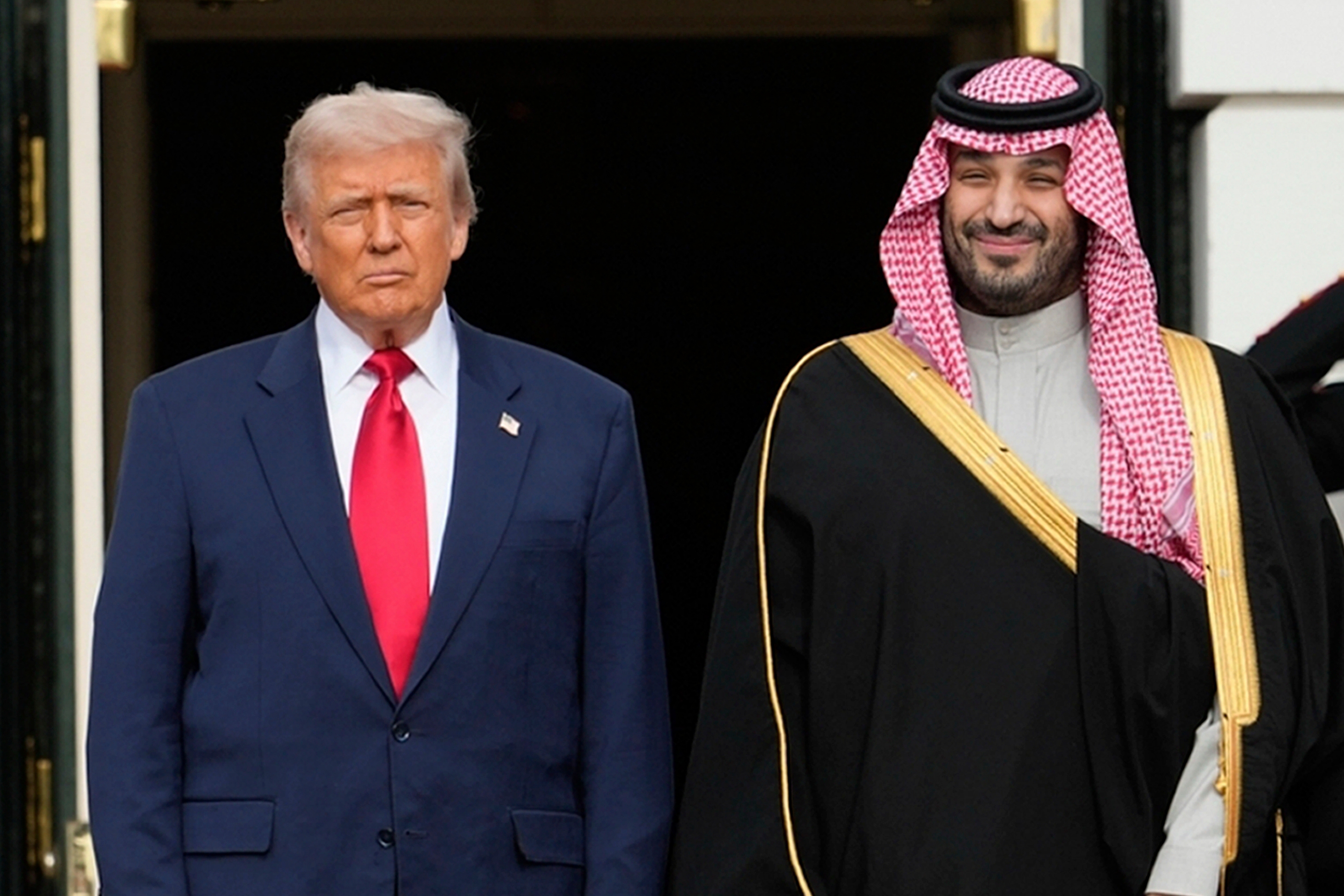 FILE - President Donald Trump stands with Saudi Arabia's Crown Prince Mohammed bin Salman on his visit to the White House, Nov. 18, 2025, in Washington. (AP Photo/Mark Schiefelbein, File)