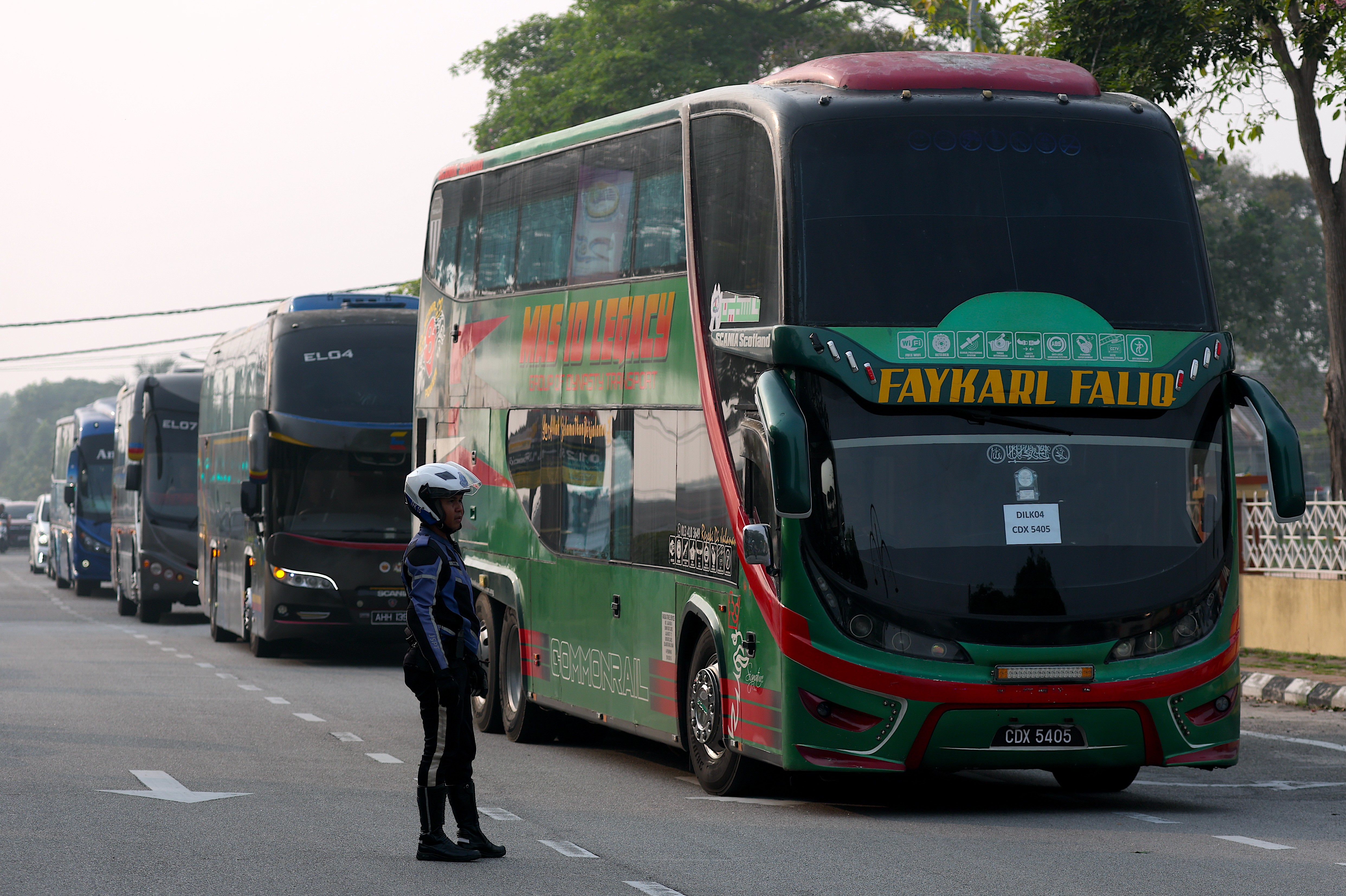 Buses carry the first batch of Myanmar nationals in Manjung in Perak state of Malaysia, September 29, 2026