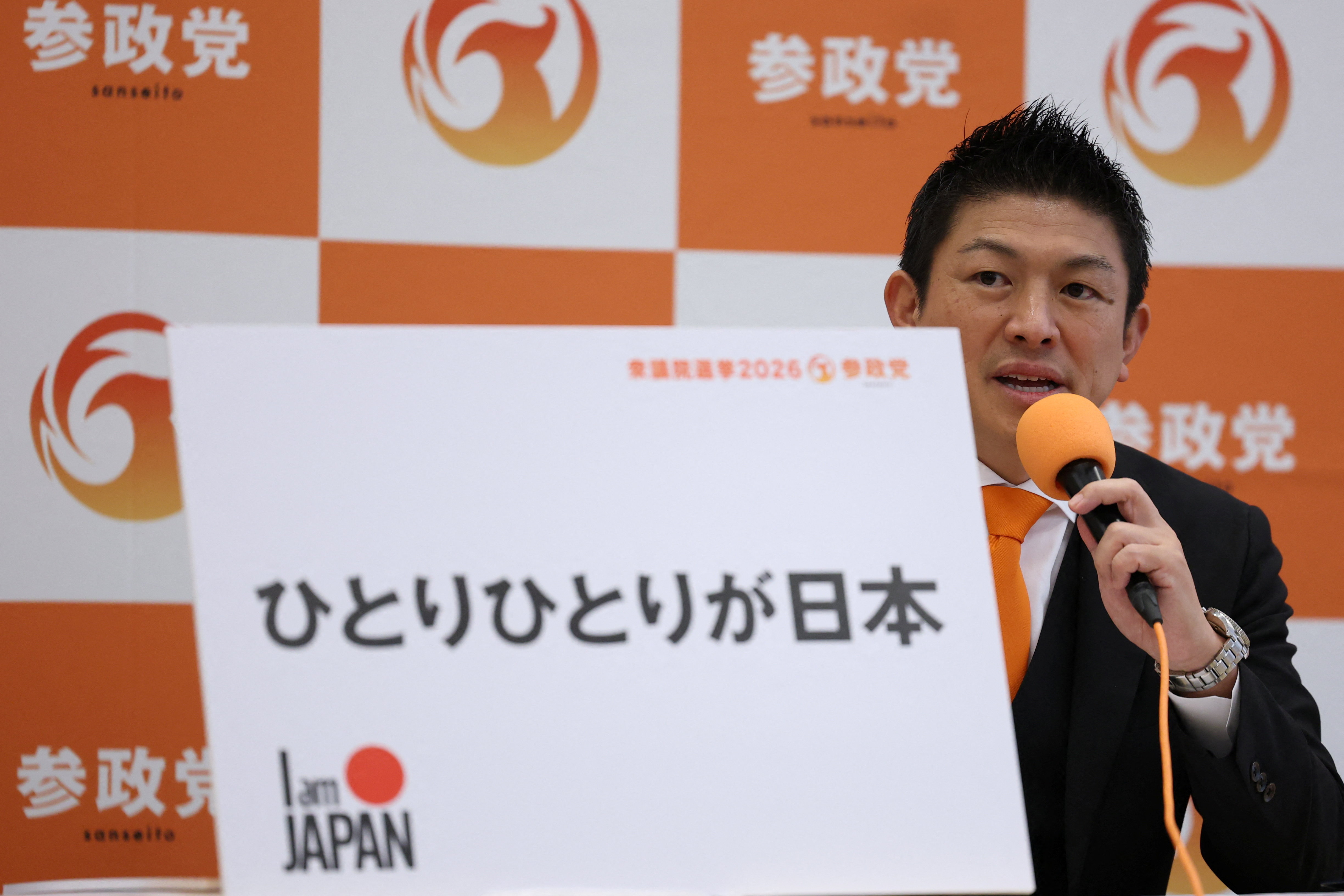 Japan’s far-right Sanseito party leader, Sohei Kamiya, shows his party’s election pledge during a news conference after Japan’s Prime Minister Sanae Takaichi dissolved the lower house of parliament, in Tokyo, January 23, 2026