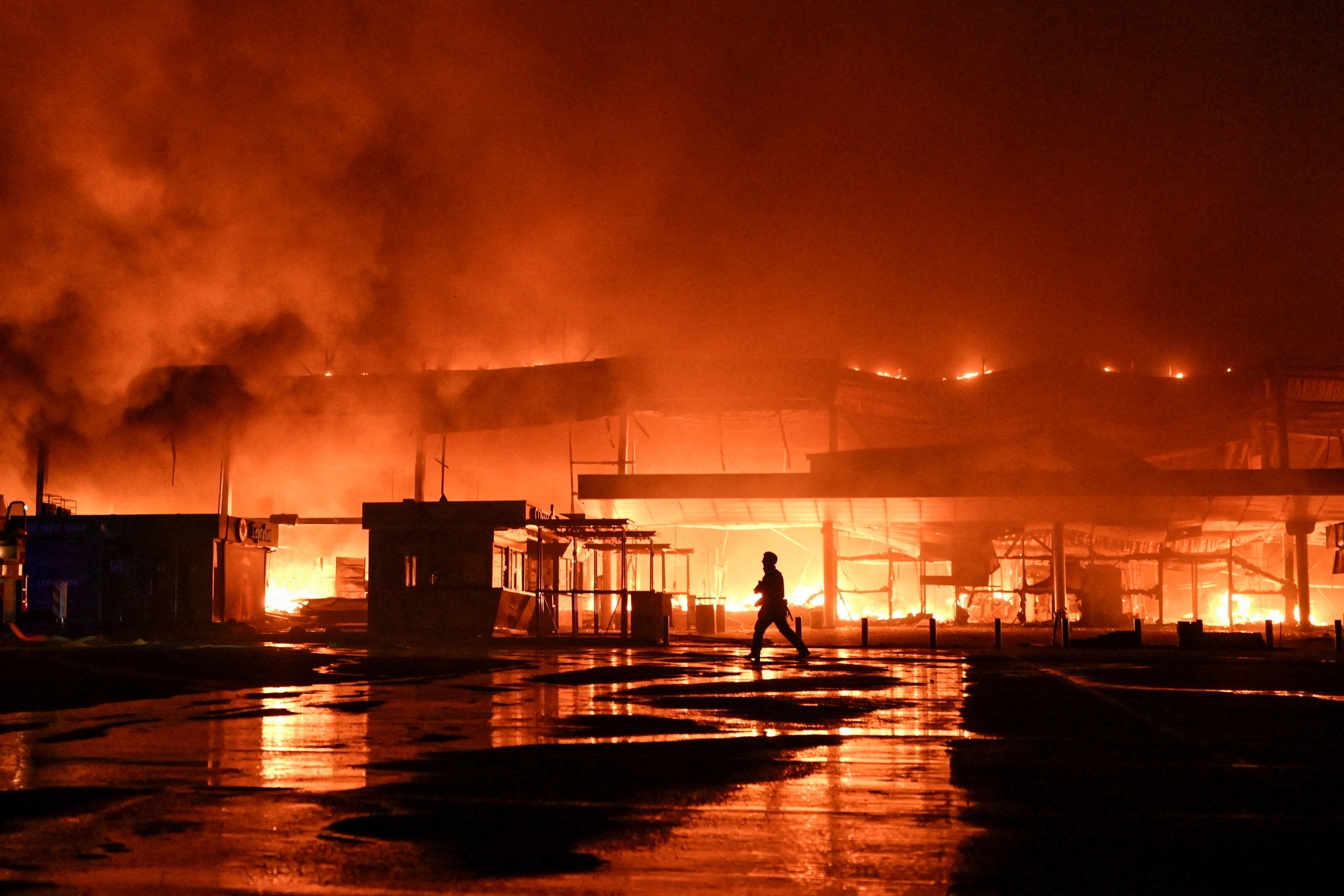 A firefighter works at the site of a shopping mall.