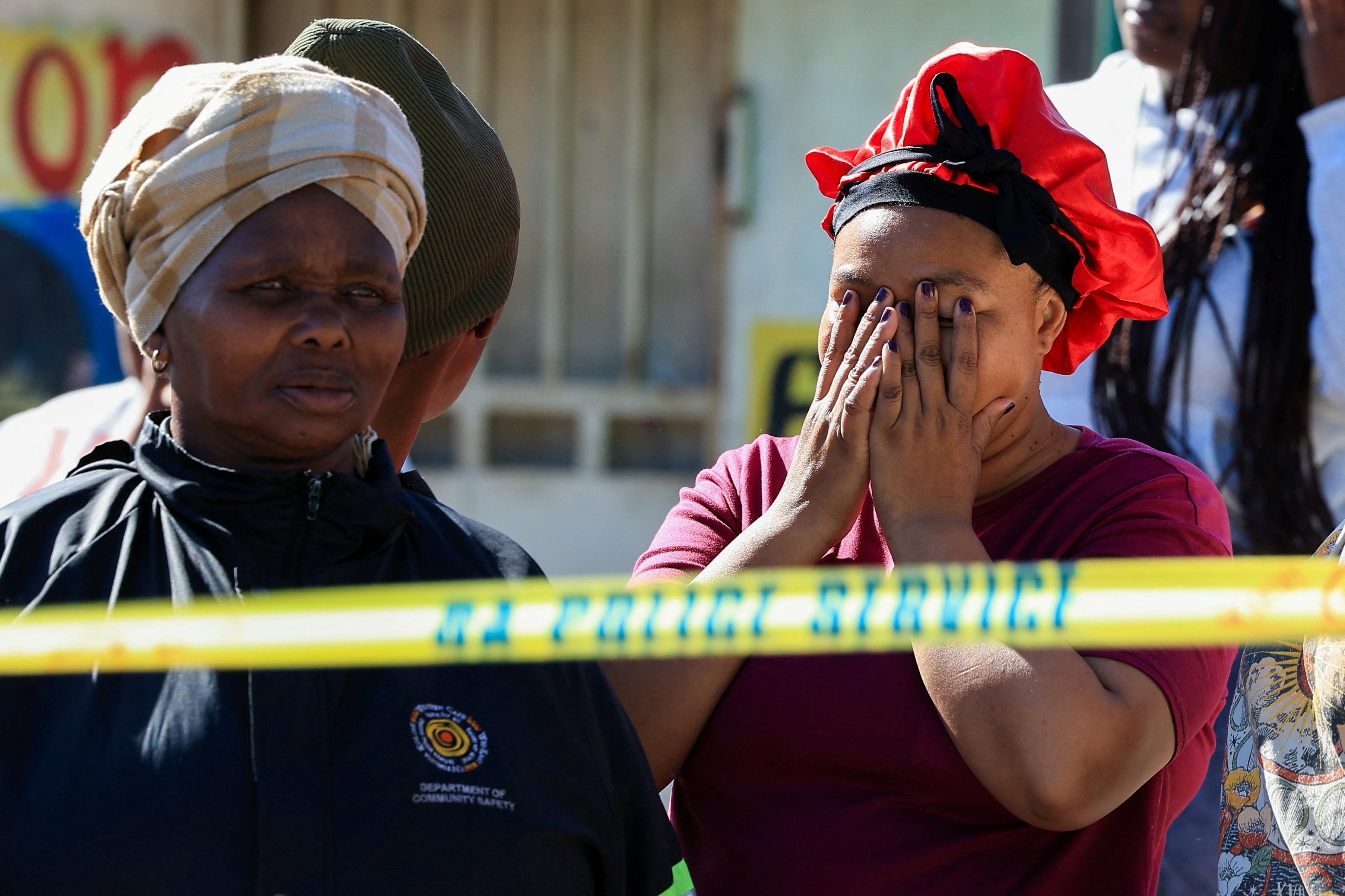 A person reacts at the site of a shooting in Lwandle in the Western Cape, South Africa
