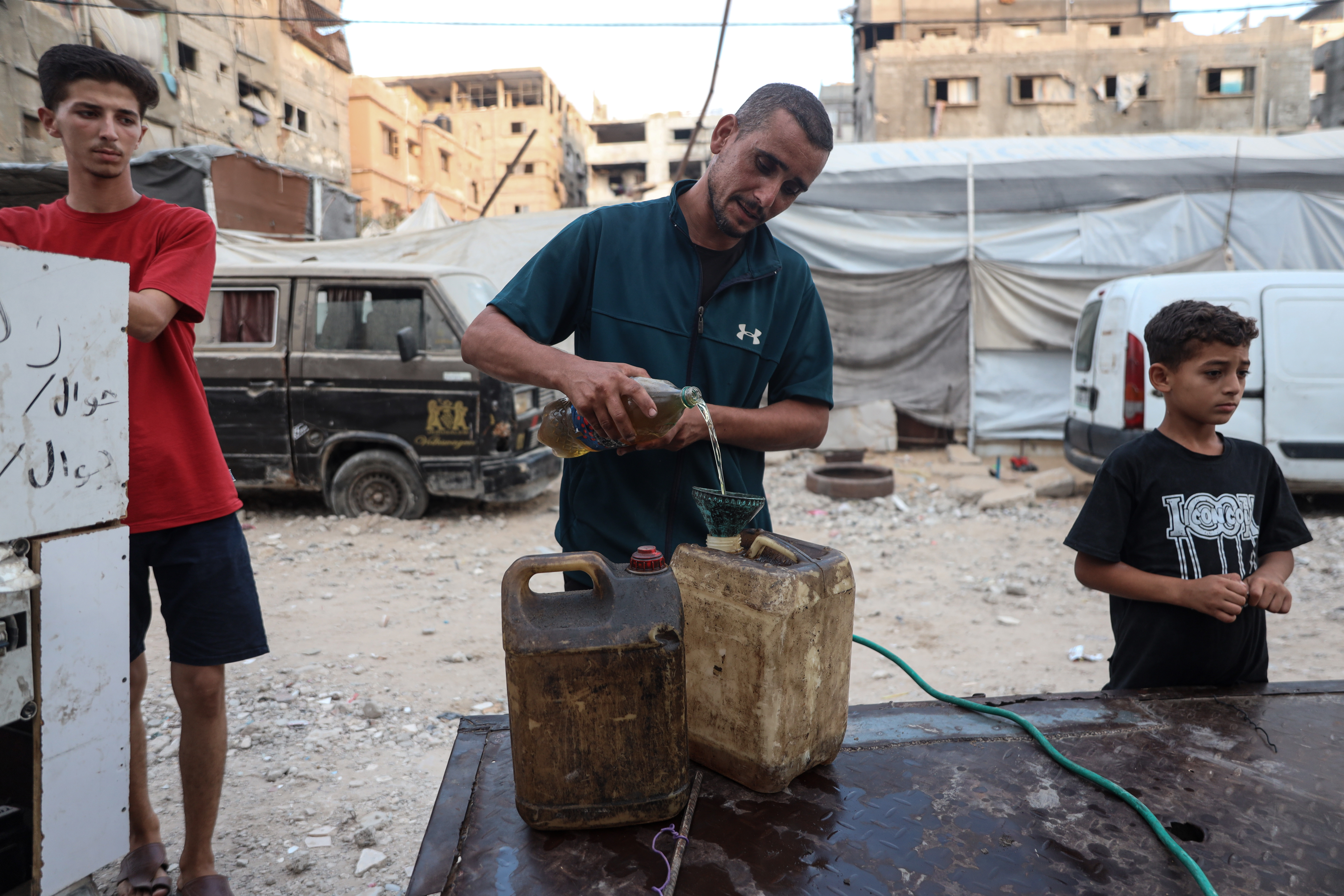 A man fills a fuel tank.