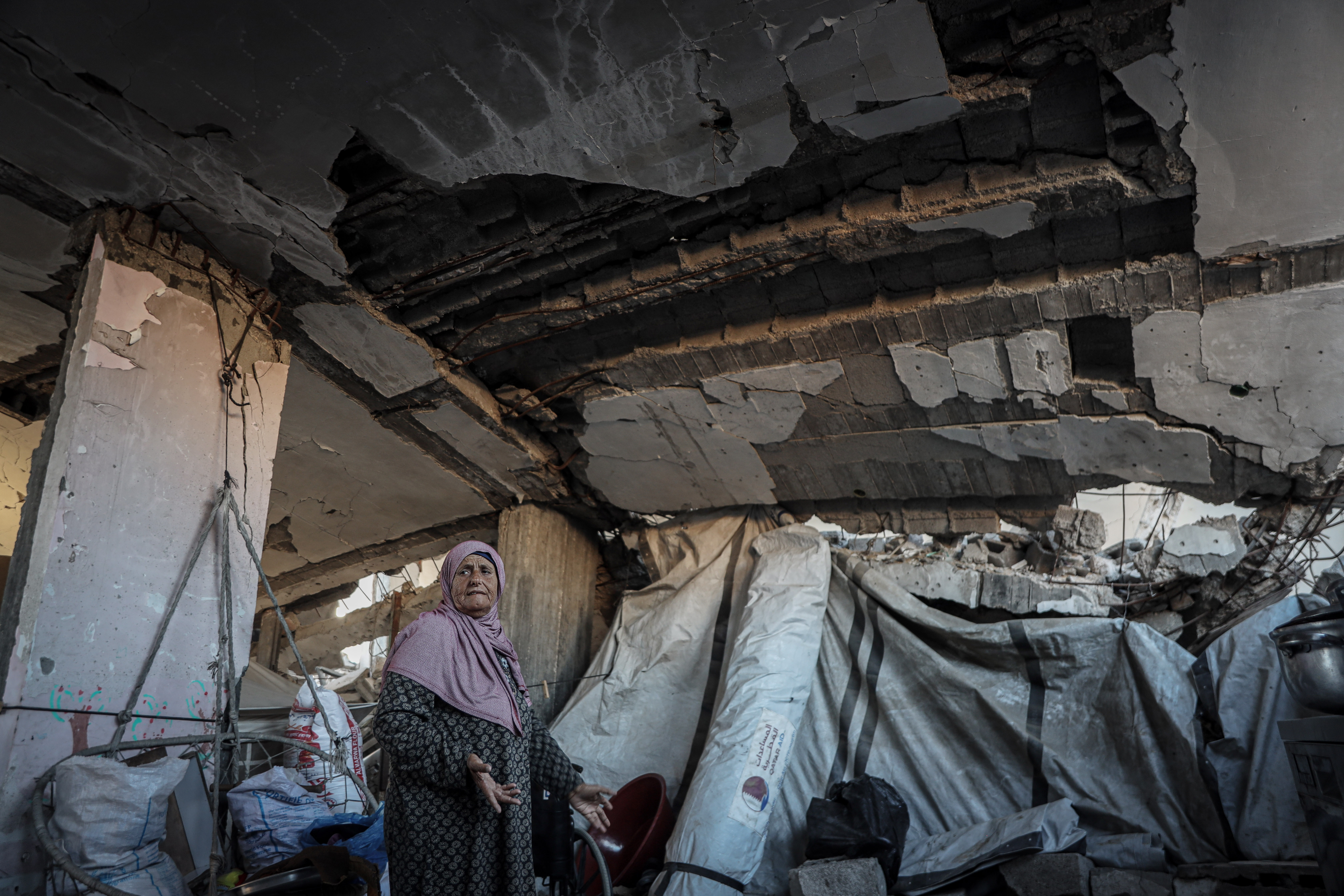 Masada Abu Jarad shows the ceiling of the destroyed home she lives in fearing the structure could collapse. [Abdelhakim Abu Riash/ Al Jazeera]