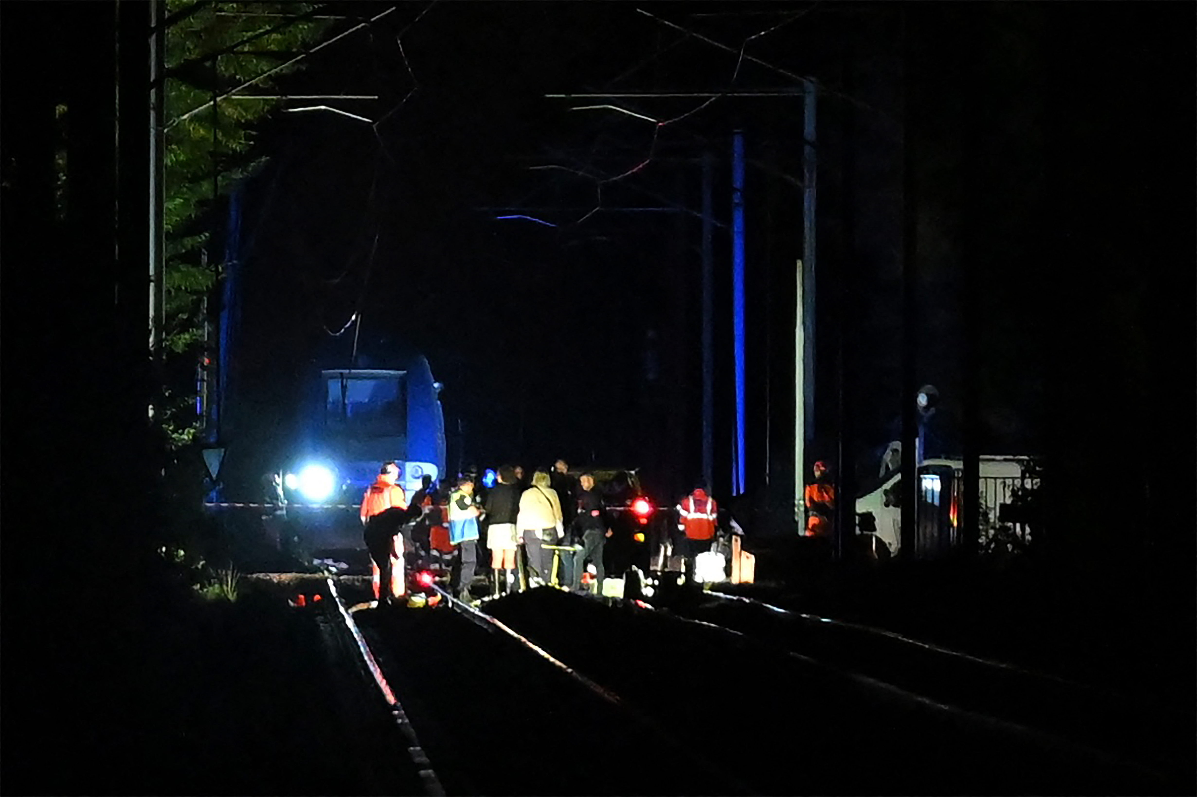 Rescue members work at the site after a train carrying 180 passengers derailed, injuring around 20 people, in Cleon, northwestern France on September 11, 2026.