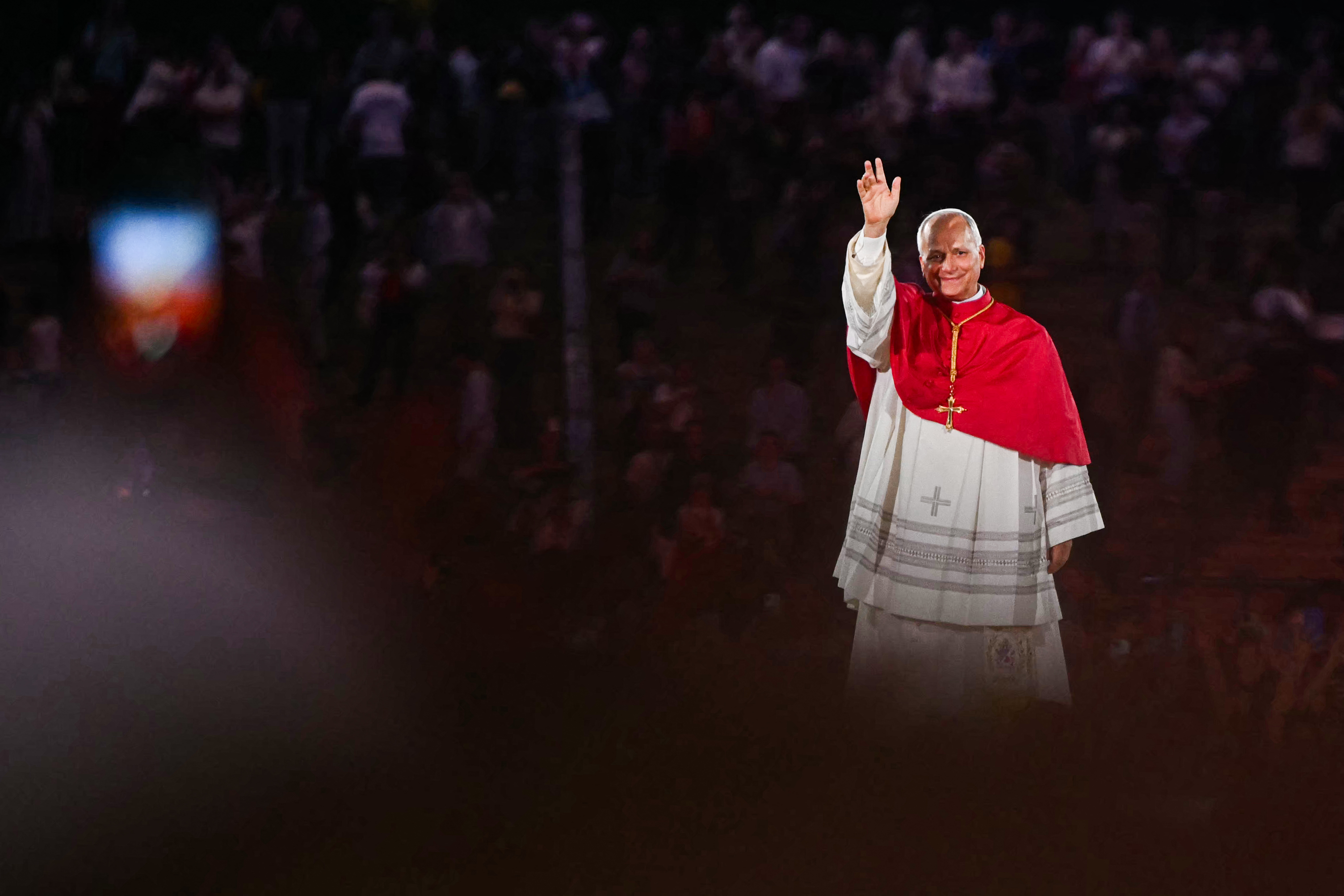 Pope Leo XIV waves to the crowd as he leaves at the end of a prayer vigil with young people at the Stade de France stadium, in Saint-Denis on the outskirts of Paris. [AFP]