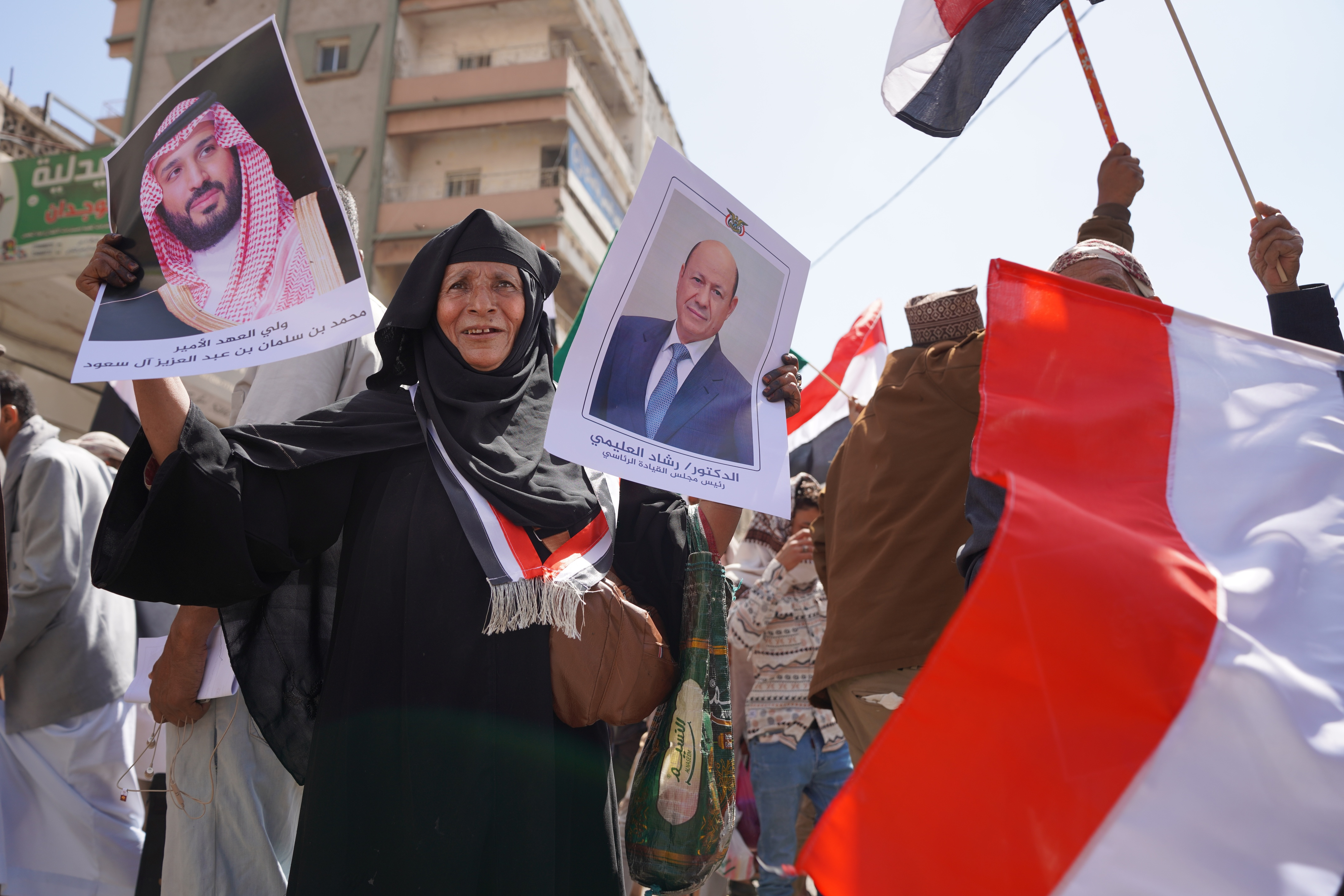 A protester holds posters of Rashad al-Alimi, head of the Presidential Leadership Council, and Saudi Crown Prince Mohammed bin Salman during a march to protest Iranian attacks on Saudi Arabia in Taiz, Yemen, Monday, March 30, 2026. [Abdulnasser Alseddik/AP Photo]