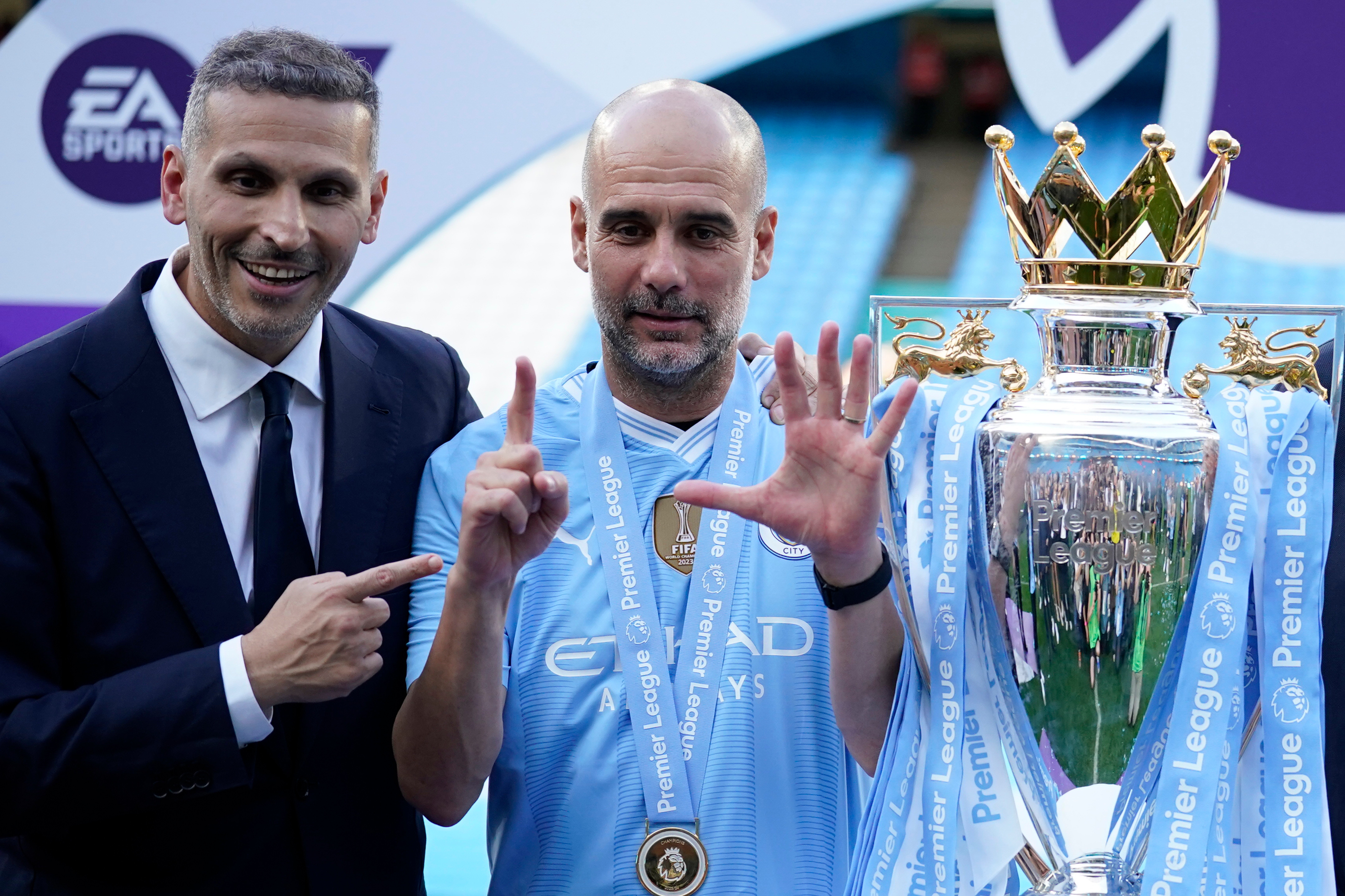 FILE - Manchester City's head coach Pep Guardiola, right, and chairman Khaldoon Al Mubarak celebrate with the Premier League trophy after the English Premier League soccer match between Manchester City and West Ham United in Manchester, England, Sunday, May 19, 2024. (AP Photo/Dave Thompson, File)