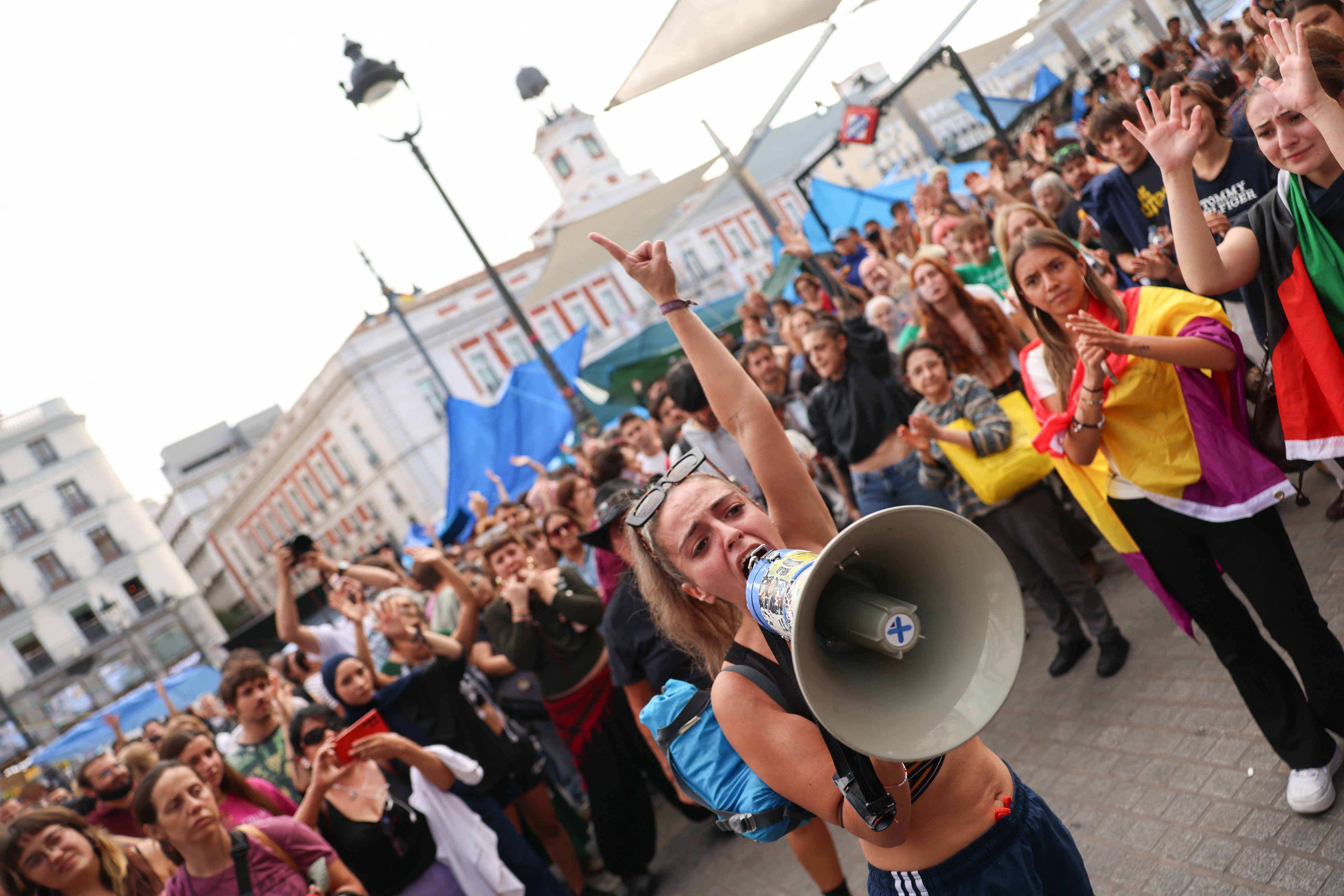 People shout slogans as protesters camp at Madrid's downtown square, Puerta del Sol, demanding political action to stop evictions and alleviate the housing crisis, after the forceful eviction of an 87-year-old woman from her apartment in Madrid, Spain, September 29, 2026. REUTERS/Susana Vera