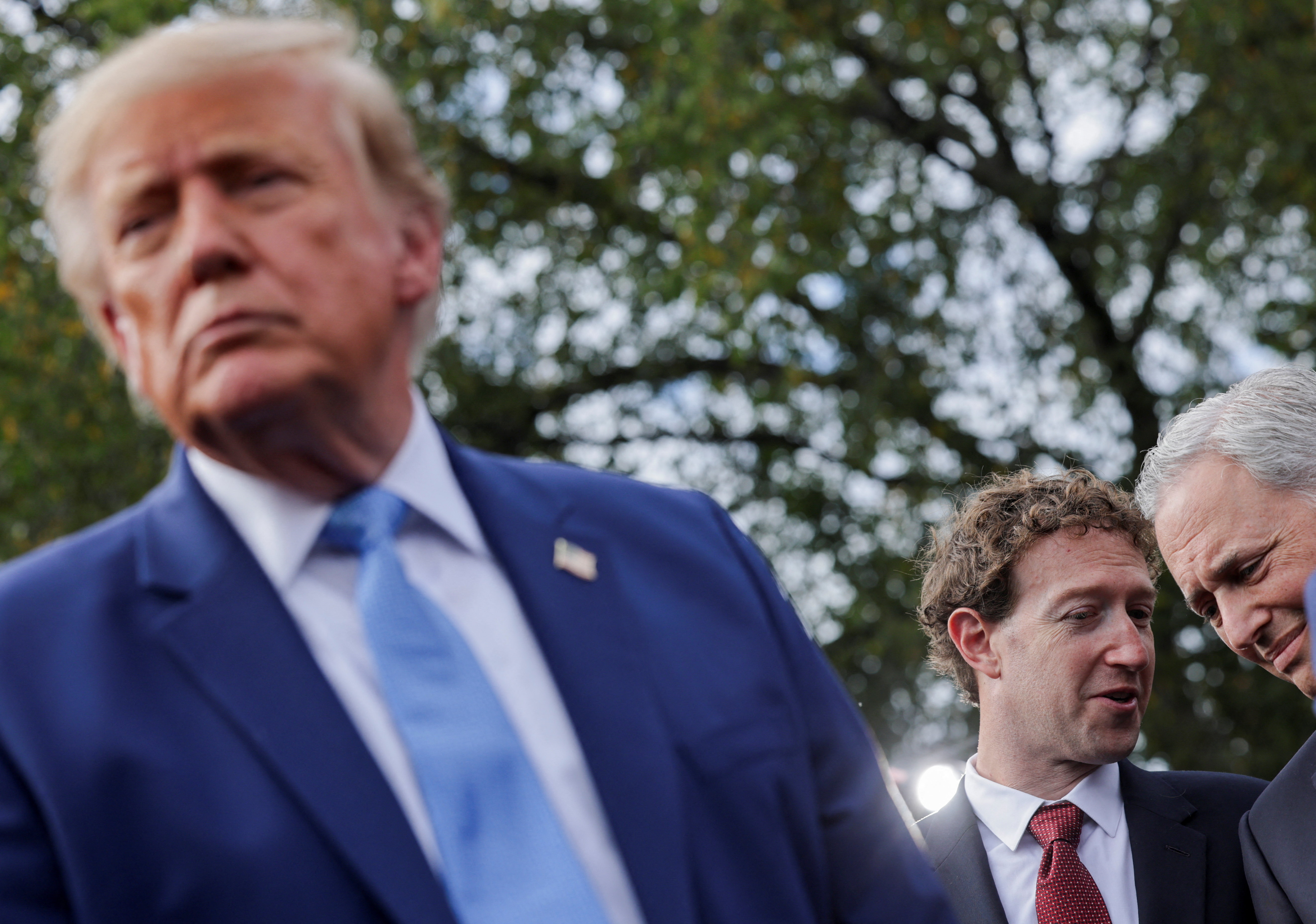 President Donald Trump speaks to the press at the White House driveway