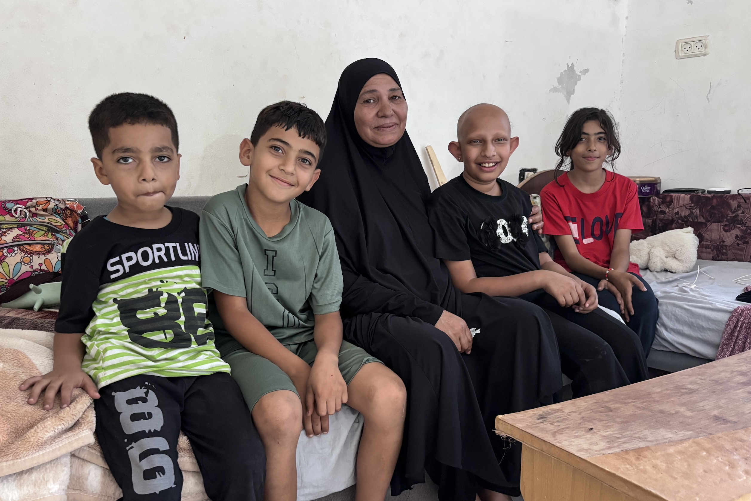 Khadija and some grandchildren of hers on their couch