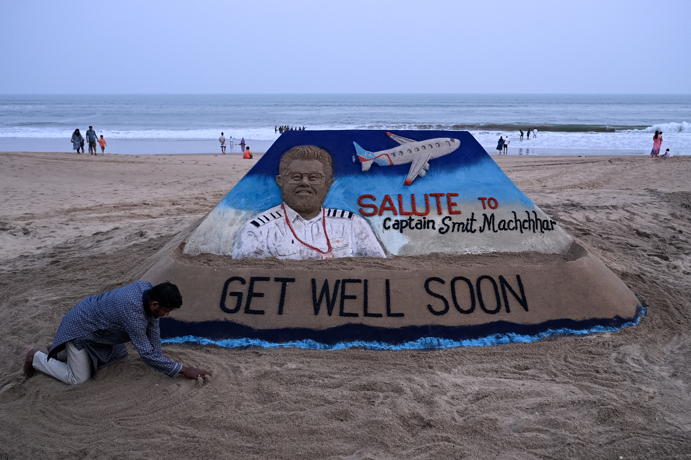 A sculpture made by India's sand artist Sudarsan Pattnaik depicts India's pilot Smit Machchhar, the captain of flydubai flight FZ 1073, at a beach in Odisha's Puri city on October 1, 2026.
