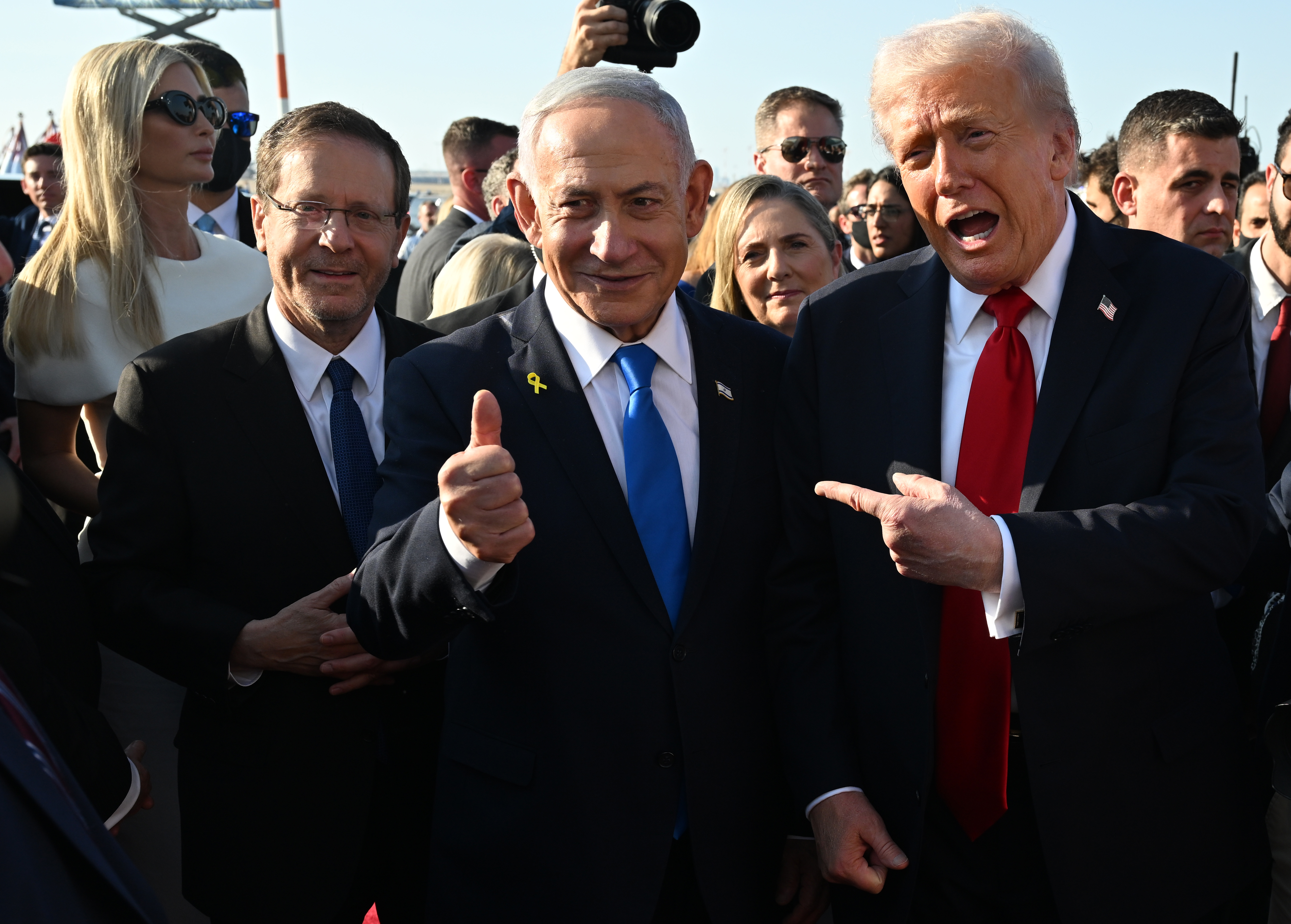 TEL AVIV, ISRAEL - OCTOBER 13: U.S. President Donald Trump poses with Israeli President Isaac Herzog and Israeli Prime Minister Benjamin Netanyahu at Ben Gurion International Airport before boarding his plane to Sharm El-Sheikh, on October 13, 2025 in Tel Aviv, Israel. President Trump is visiting the country hours after Hamas released the remaining Israeli hostages captured on Oct. 7, 2023, part of a US-brokered ceasefire deal to end the war in Gaza. (Photo by Chip Somodevilla/Getty Images)