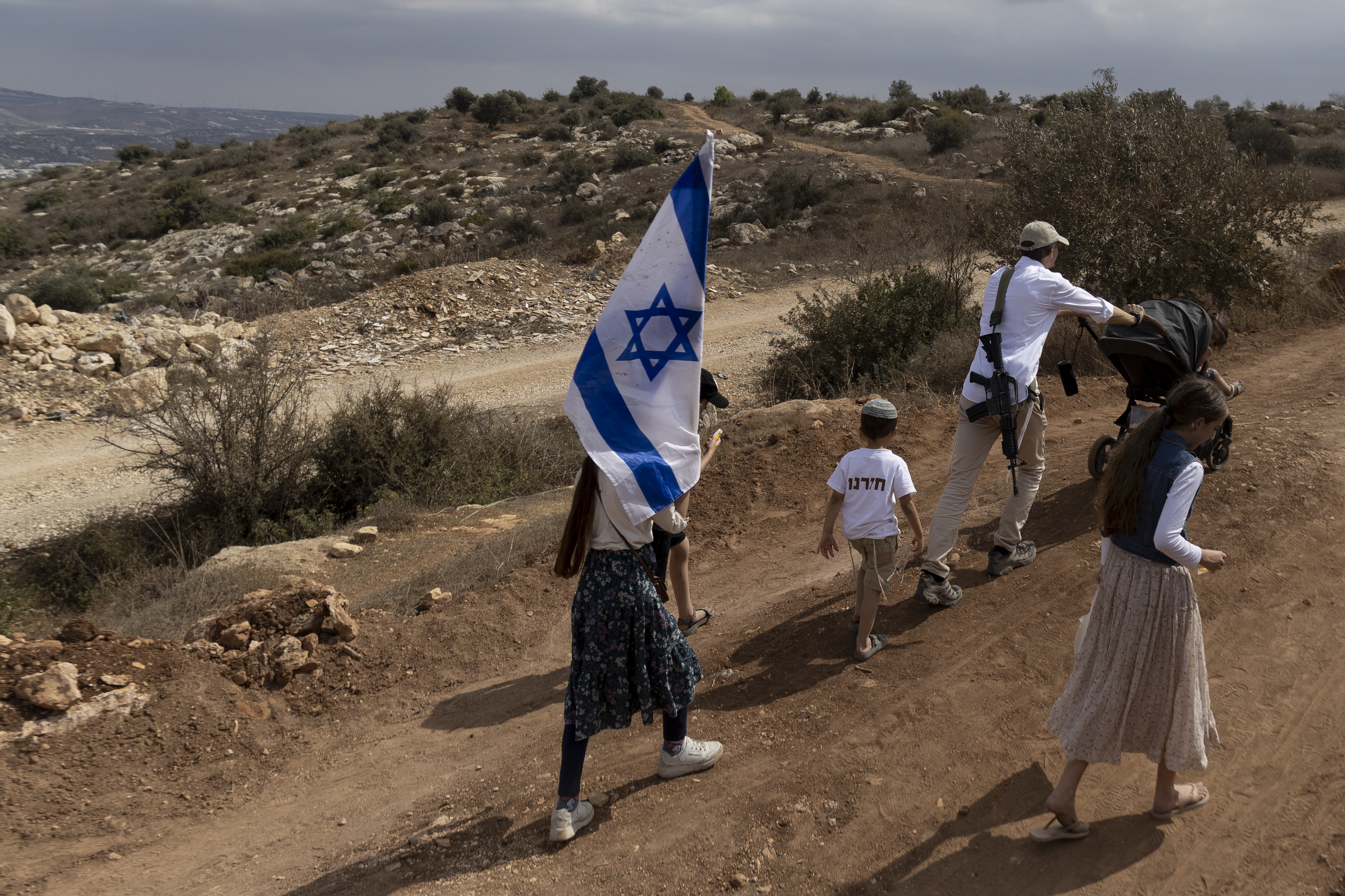 KADIM, WEST BANK - SEPTEMBER 30: Jewish Israelis hold Israeli flag during a march in support of the newly re-established Israeli settlements in northern West Bank near the re-established Jewish settlement of Kadim at the out skirt of the Palestinian city of Jenin in Northern West Bank on September 30, 2026 in Kadim, West Bank. The settlements here, which are considered illegal under international law, had been evacuated and demolished in 2005 under a previous Israeli government. (Photo by Amir Levy/Getty Images)