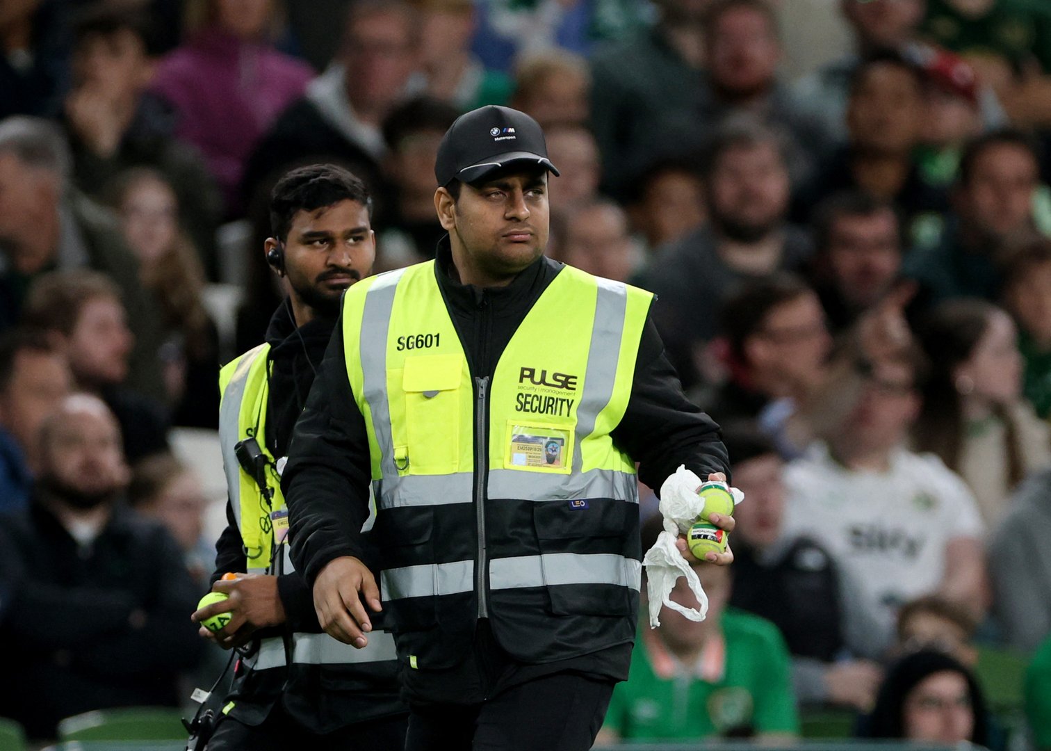 UEFA Nations League - Group B3 - Republic of Ireland v Austria - Aviva Stadium, Dublin, Ireland - October 1, 2026 A steward carries tennis balls which were thrown onto the pitch as part of a protest during the match. [REUTERS/Cathal Mcnaughton]