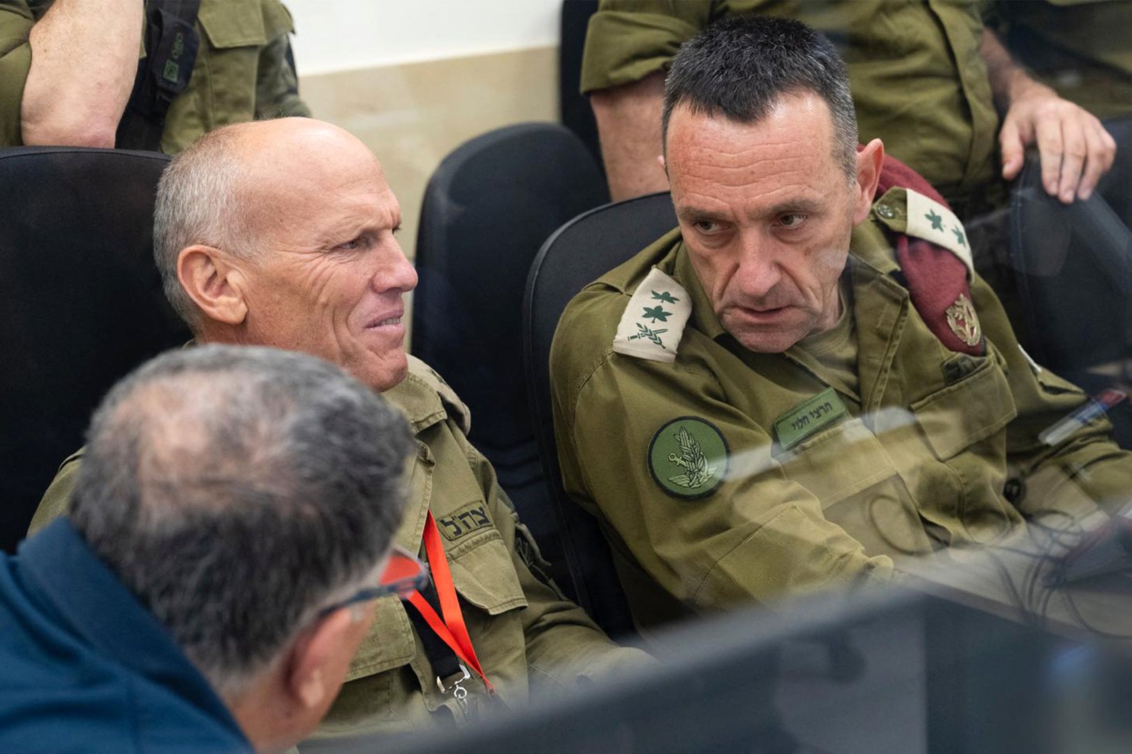 This handout picture released by the Israeli army shows (L to R) the Head of the Hostages and Missing Persons Headquarters Major-General Nitzan Alon and Israeli army Chief of the General Staff Lieutenant-General Herzi Halevi at the Hostages and Missing Persons situation room during the return of the four hostages from Gaza on January 25, 2025. [Israeli Army/AFP]